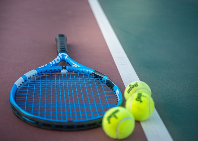 A picture of a tennis racket with tennis balls